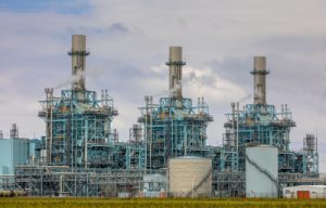 Industrial facility featuring multiple large processing towers and equipment, showcasing the engineering infrastructure for oil recovery and petrochemical industries, highlighting the essential components of system integration and digital transformation.