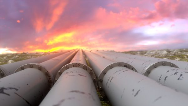 Pipelines stretch into the distance against a vibrant sky, symbolizing the critical role of engineering and system integration in North America's pipeline industry, focused on reliability and infrastructure support.