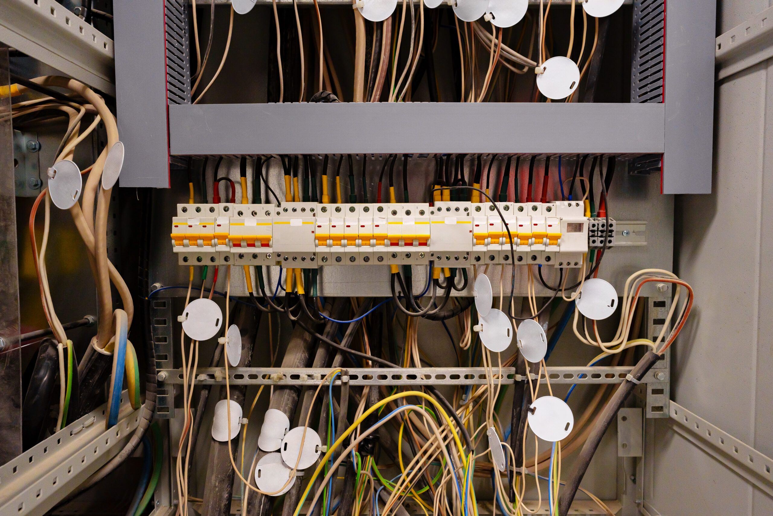 complex electrical panel with labeled wires and circuit breakers.