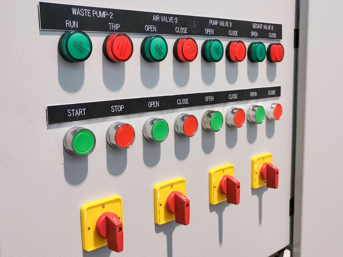 Industrial control panel with labeled switches and push buttons for valve and pump control