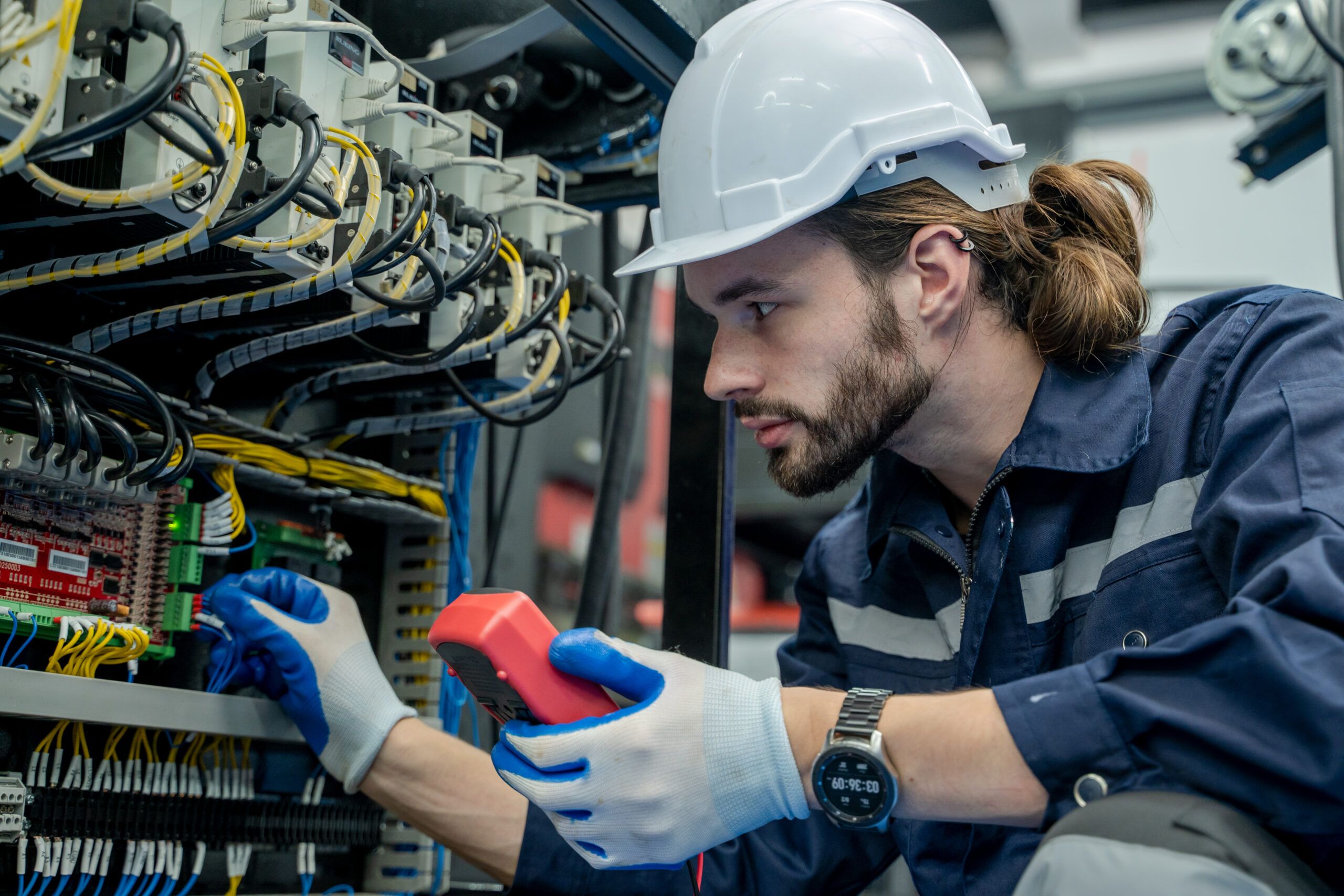 Electrical engineer testing wiring and circuits with a multimeter to ensure safety, efficiency, and system reliability
