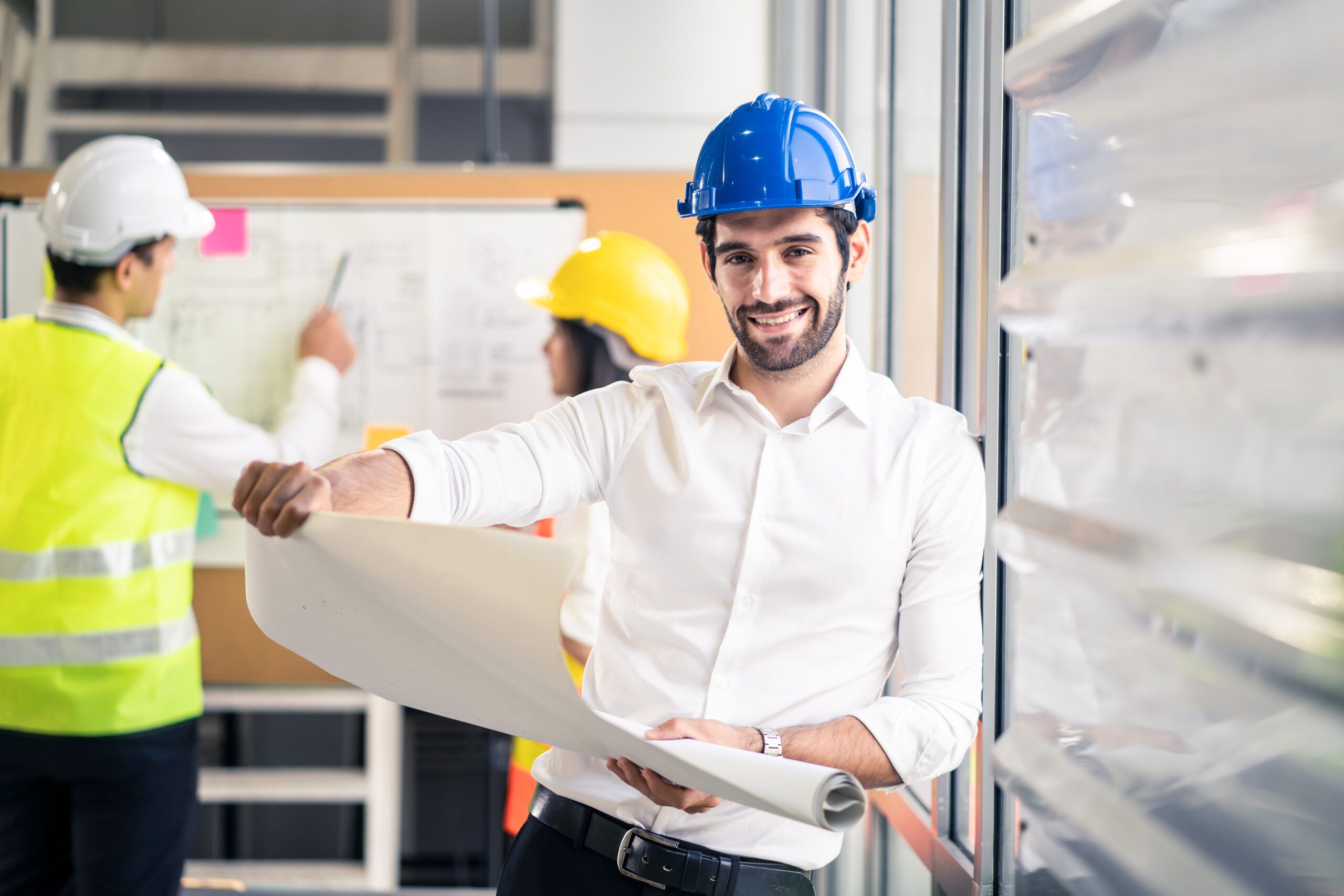 Mechanical engineers discussing project documentation in a professional setting